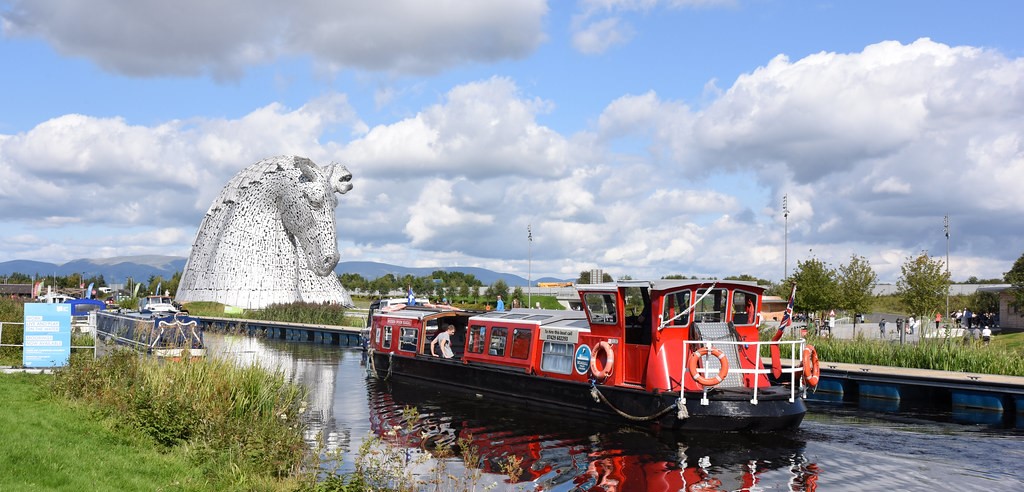 A barge passing the Helix Park Kelpies